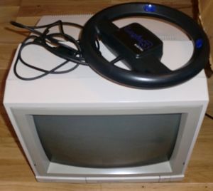 My new Commodore 1084S monitor with a Nigel Mansell wheel on top! (photo by Old School Game Blog)